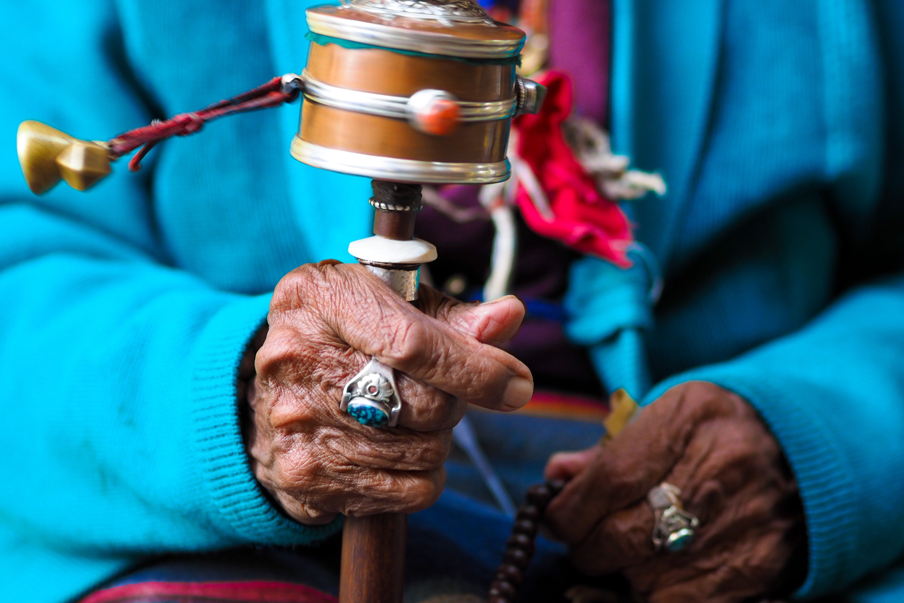 Rotation,Buddhist,Prayer,Wheel,At,Old,Woman's,Hand,,Nepal